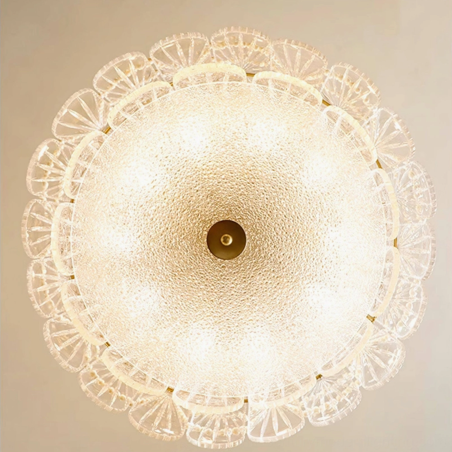Mid-century modern tiered glass chandelier with pearl-inspired beads and gold frame in window-lit interior