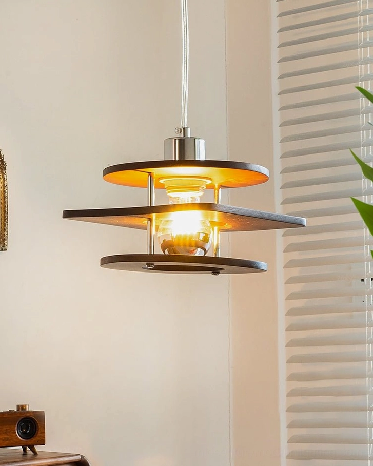 Mid-century modern walnut pendant lamp, central exposed bulb design with layered wood construction, low angle view