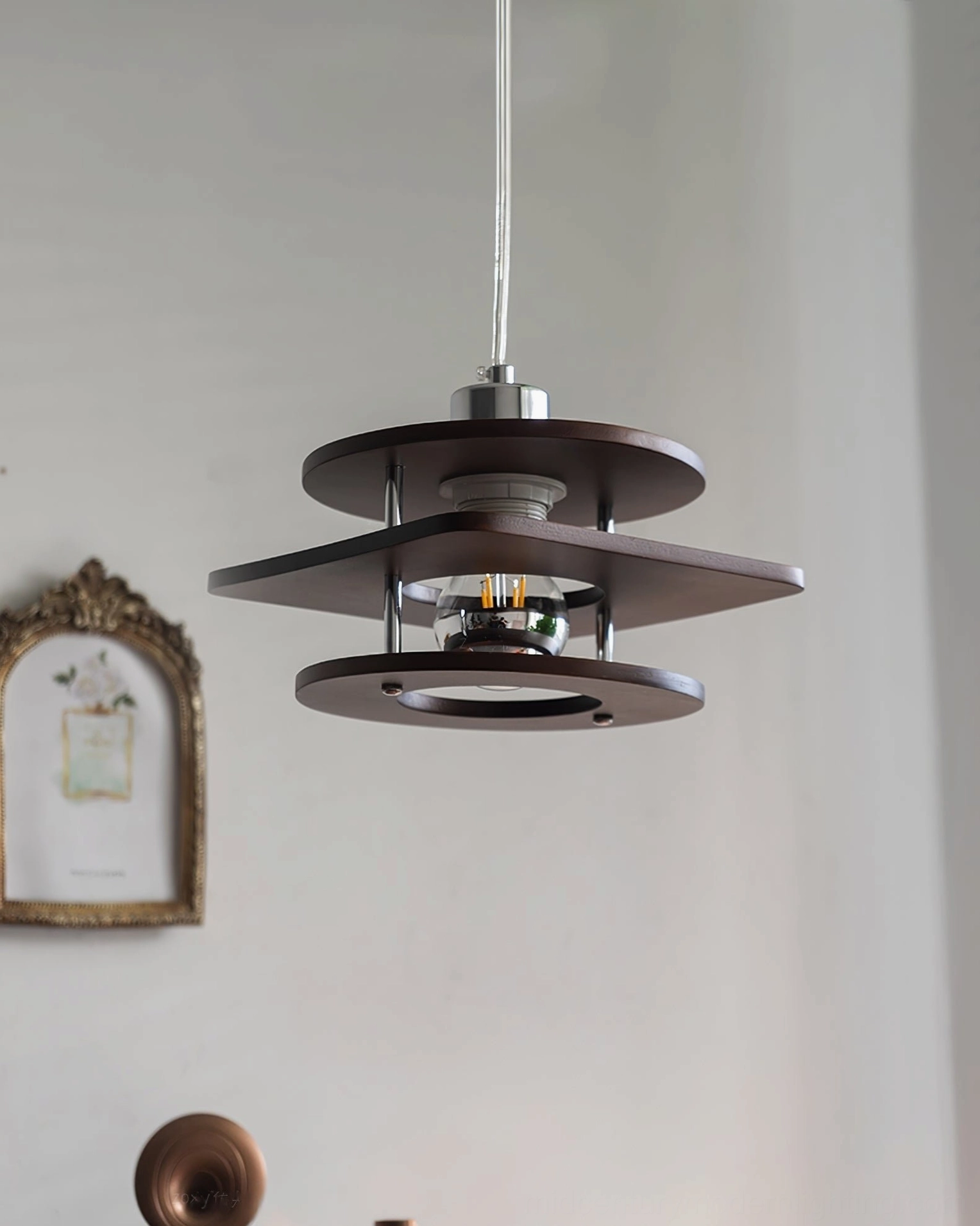 Mid-century modern pendant lamp with bottom-up tiered walnut wood shades and chrome metal hardware, unlit state