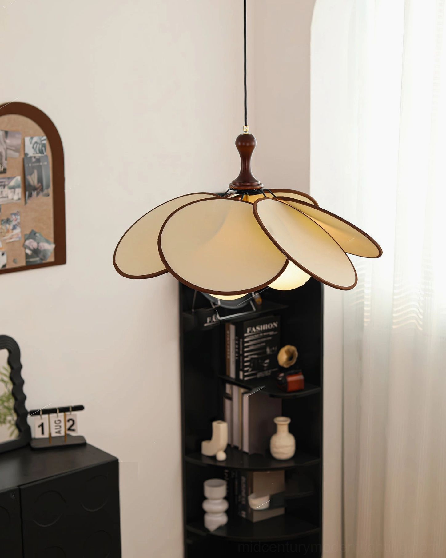 Miley pendant light side view with lit bulb and black display shelf styling