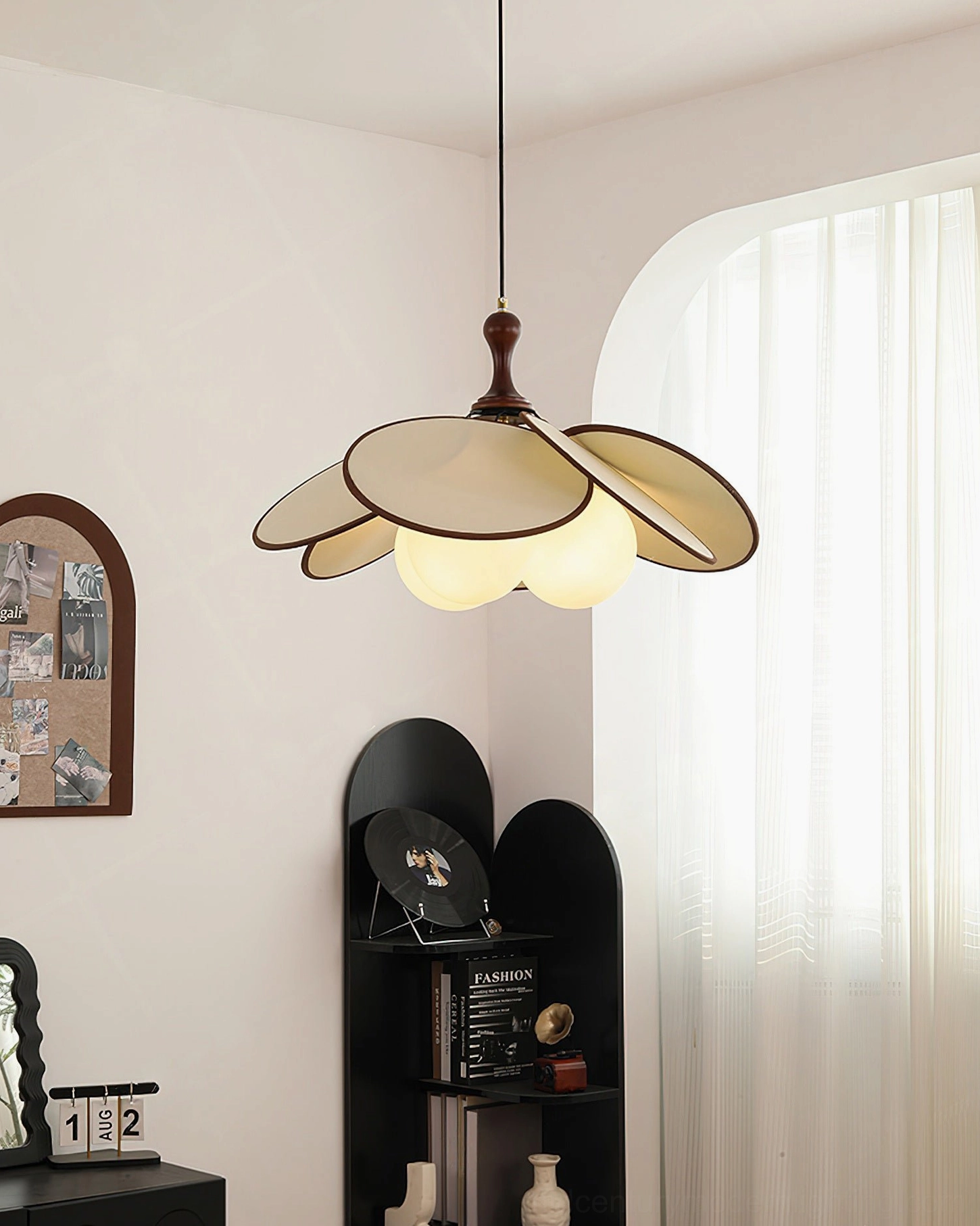 Miley pendant light three-quarter view with warm glowing bulbs in French interior with shelf