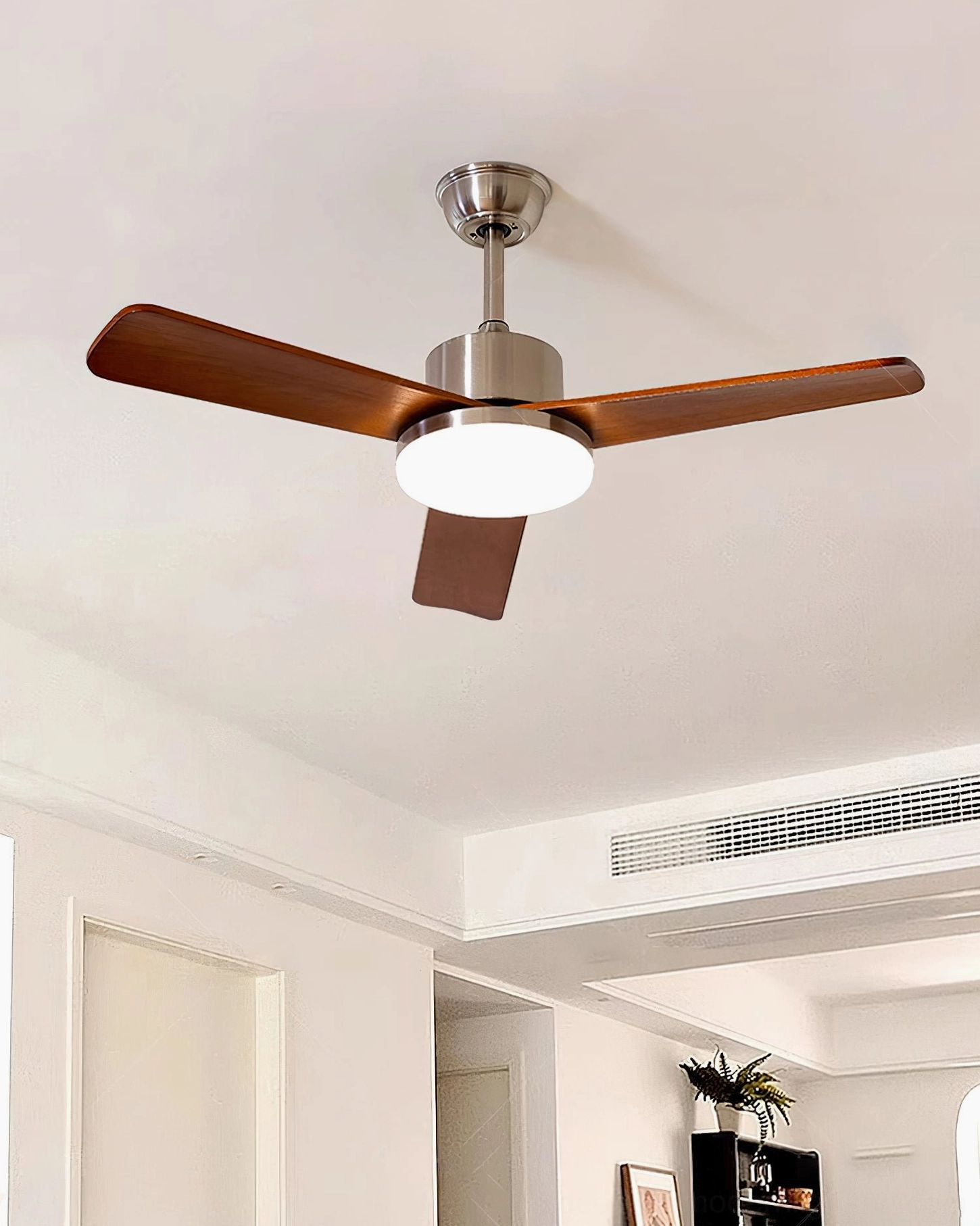 Contemporary ceiling fan light fixture in modern minimalist living room with white ceiling trim and wall-mounted AC vent