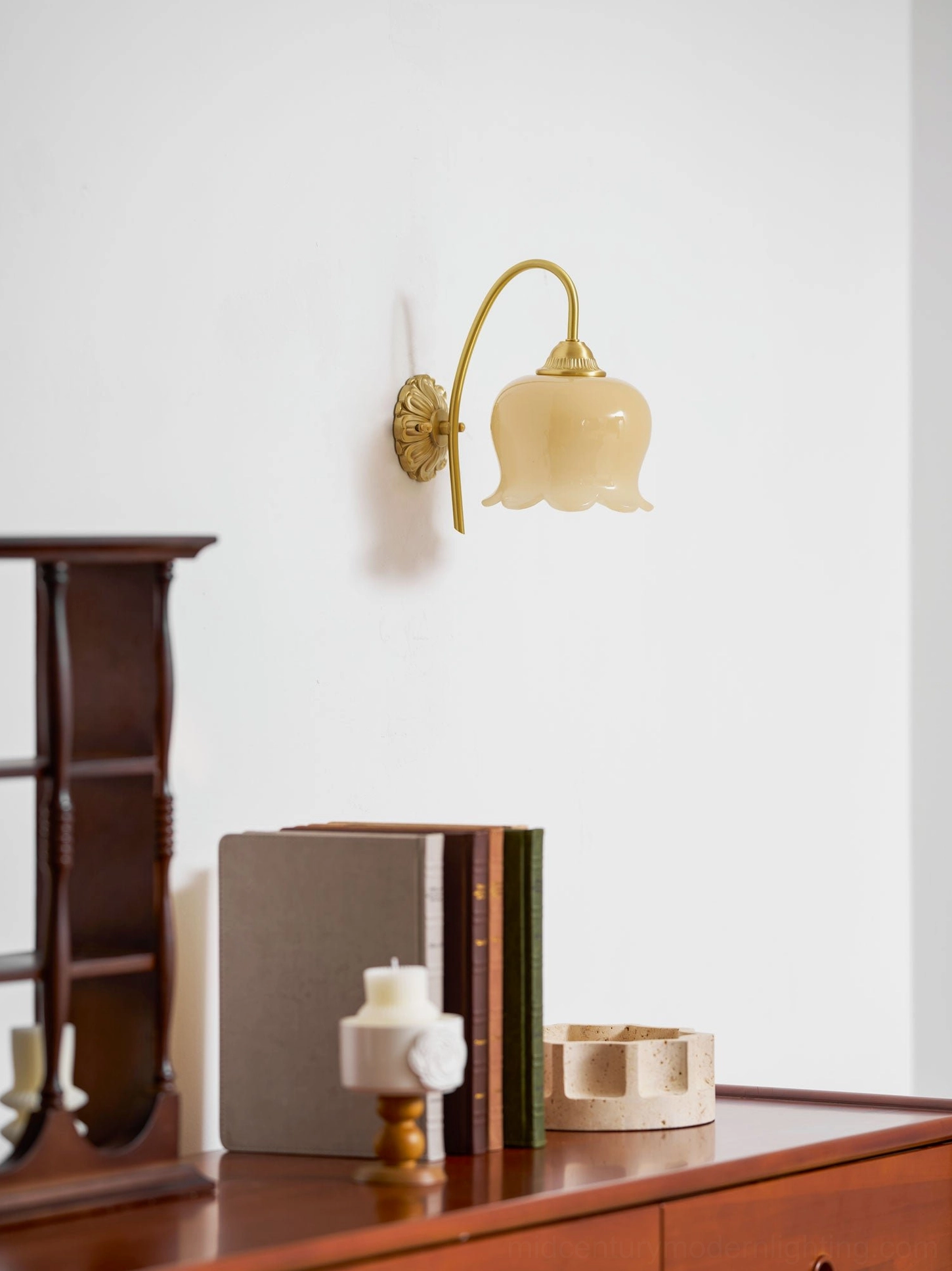 Cream colored lily of the valley wall lamp with artistic glass shade in minimalist room setting