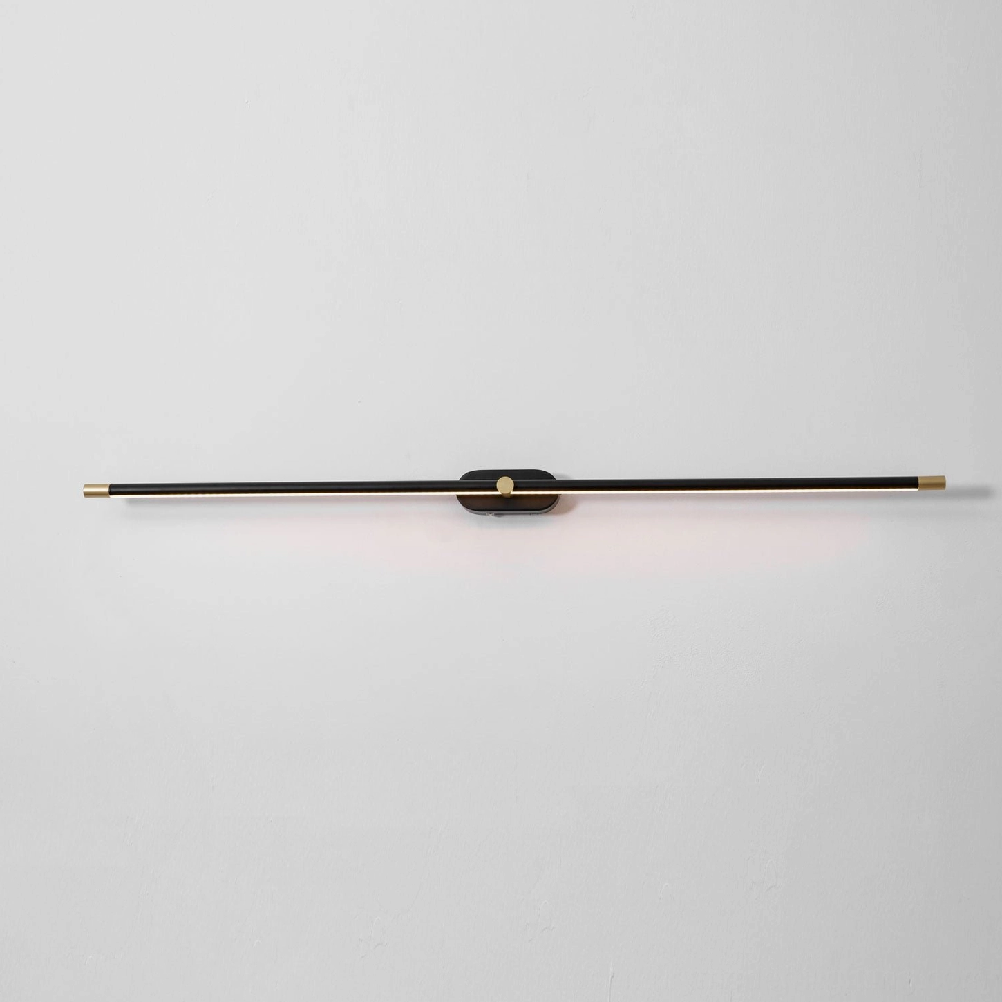 Minimalist linear wall lamp with brushed nickel finish in Scandinavian minimalist interior