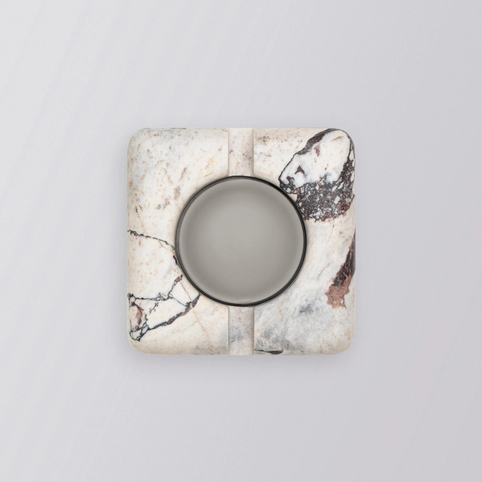 Modern minimalist marble wall lamp mounted on white surface with geometric composition