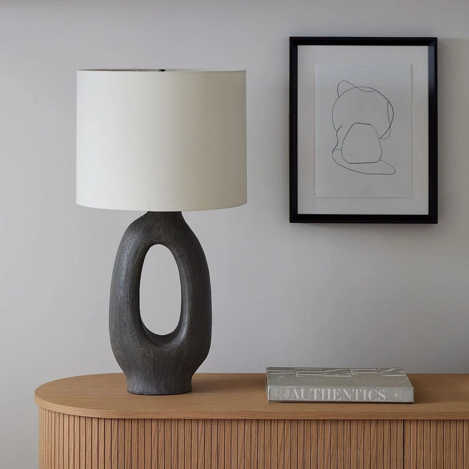 Sculptural ceramic table lamp base showing negative space design principle of minimalist interiors