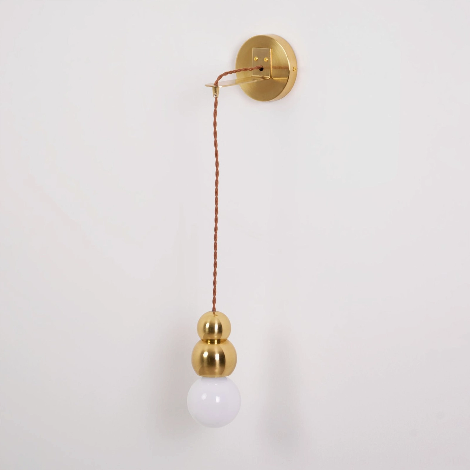 Minimalist spherical glass wall light, architectural detail, industrial metal hardware, modern aesthetic