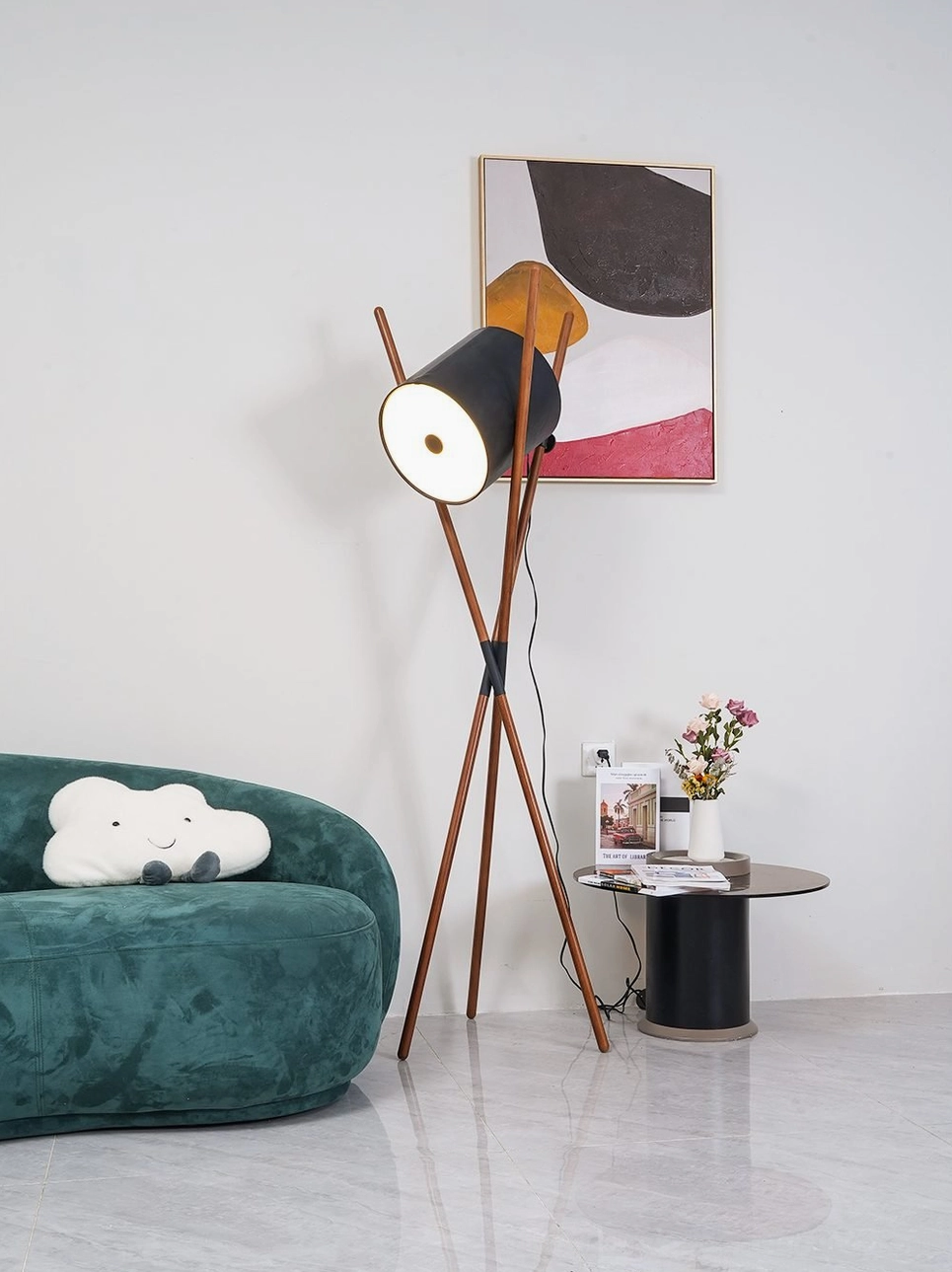 Minimalist tripod floor lamp with cylindrical shade styled in contemporary Nordic interior with velvet sofa