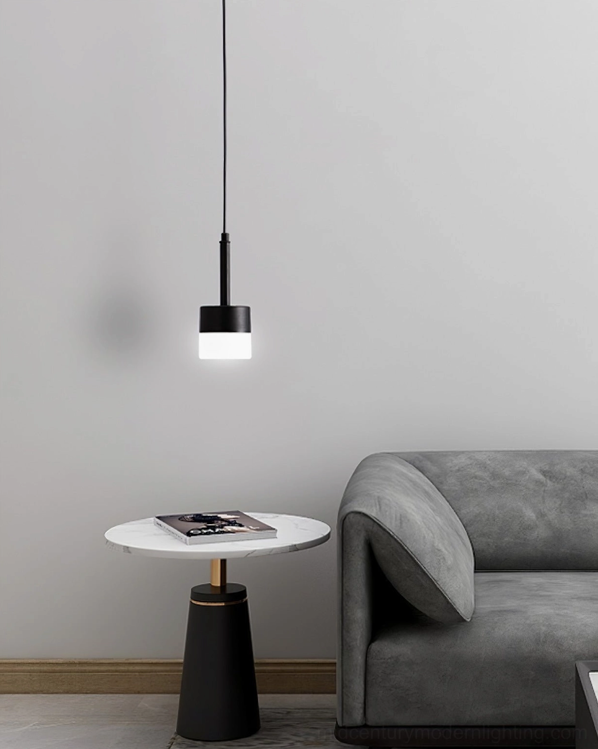 Mira black and white minimalist pendant light with sleek metal hardware over grey sofa