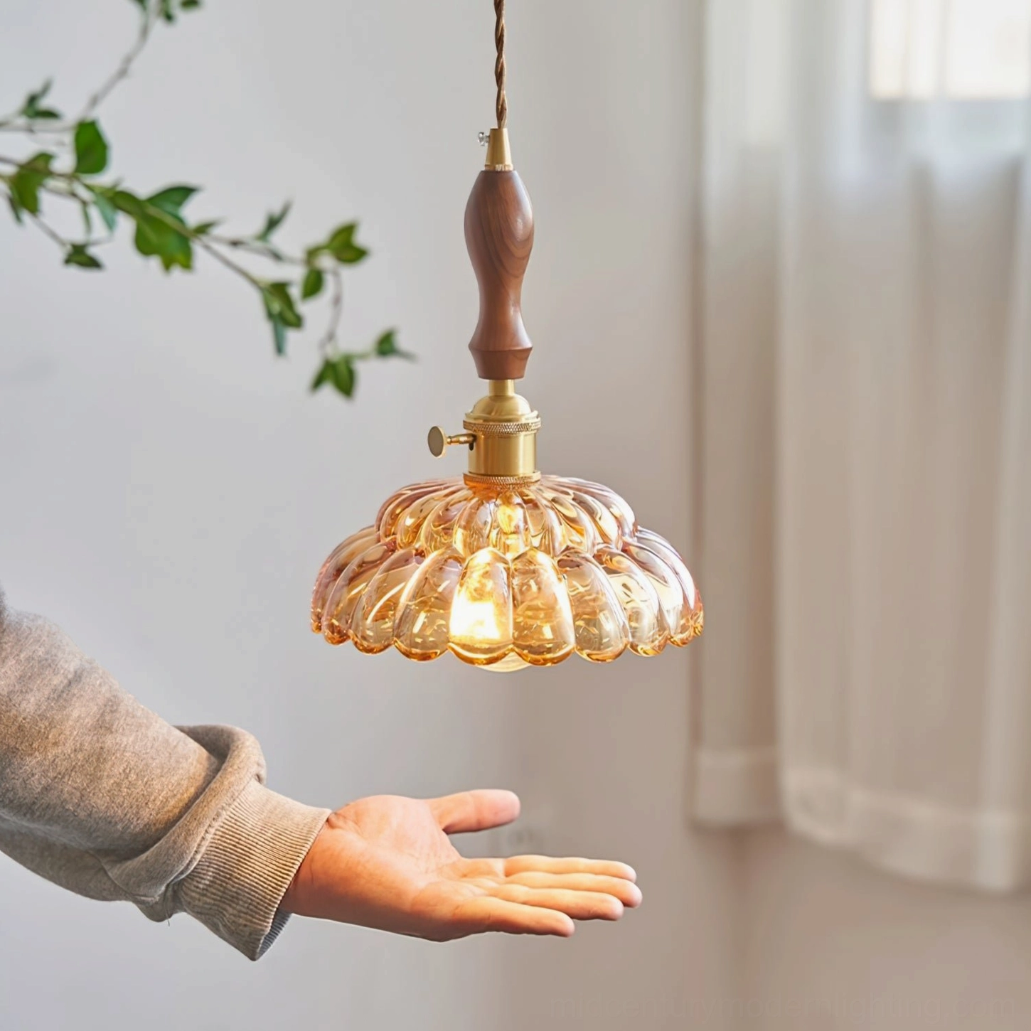 Warm amber fluted glass pendant lamp with brass hardware and wooden grip, hands-on styling with cozy indoor lighting