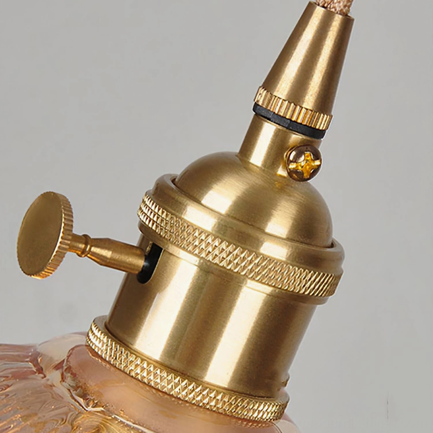 Vintage polished brass lamp socket fitting with knurled texture and rotary control mechanism, mid-century hardware