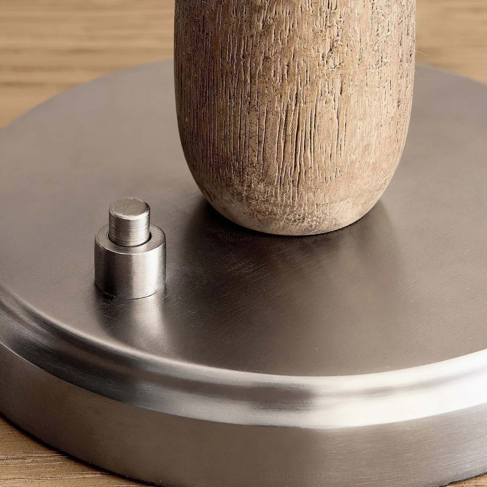 Overhead macro shot of Mitchell lamp base and natural wood pole construction on wooden surface