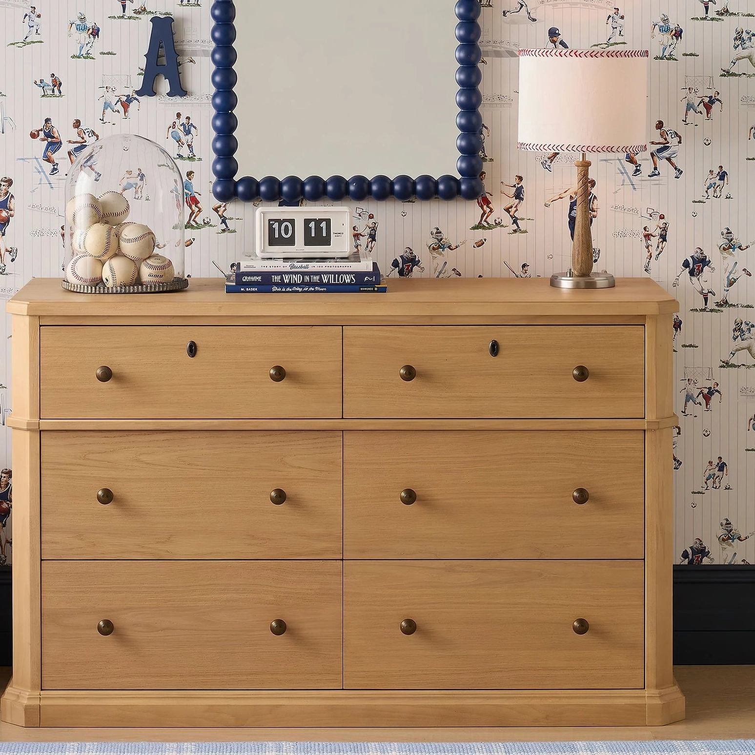 Mitchell table lamp in sports-themed kids bedroom with vintage sports wallpaper and wooden dresser decor