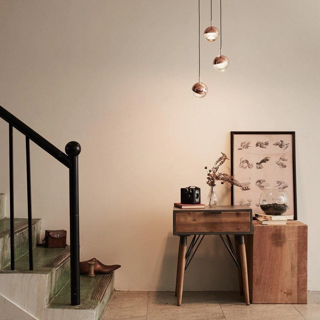 Mixed metallic spherical pendant lights in modern home entry stairwell accent lighting minimalist design