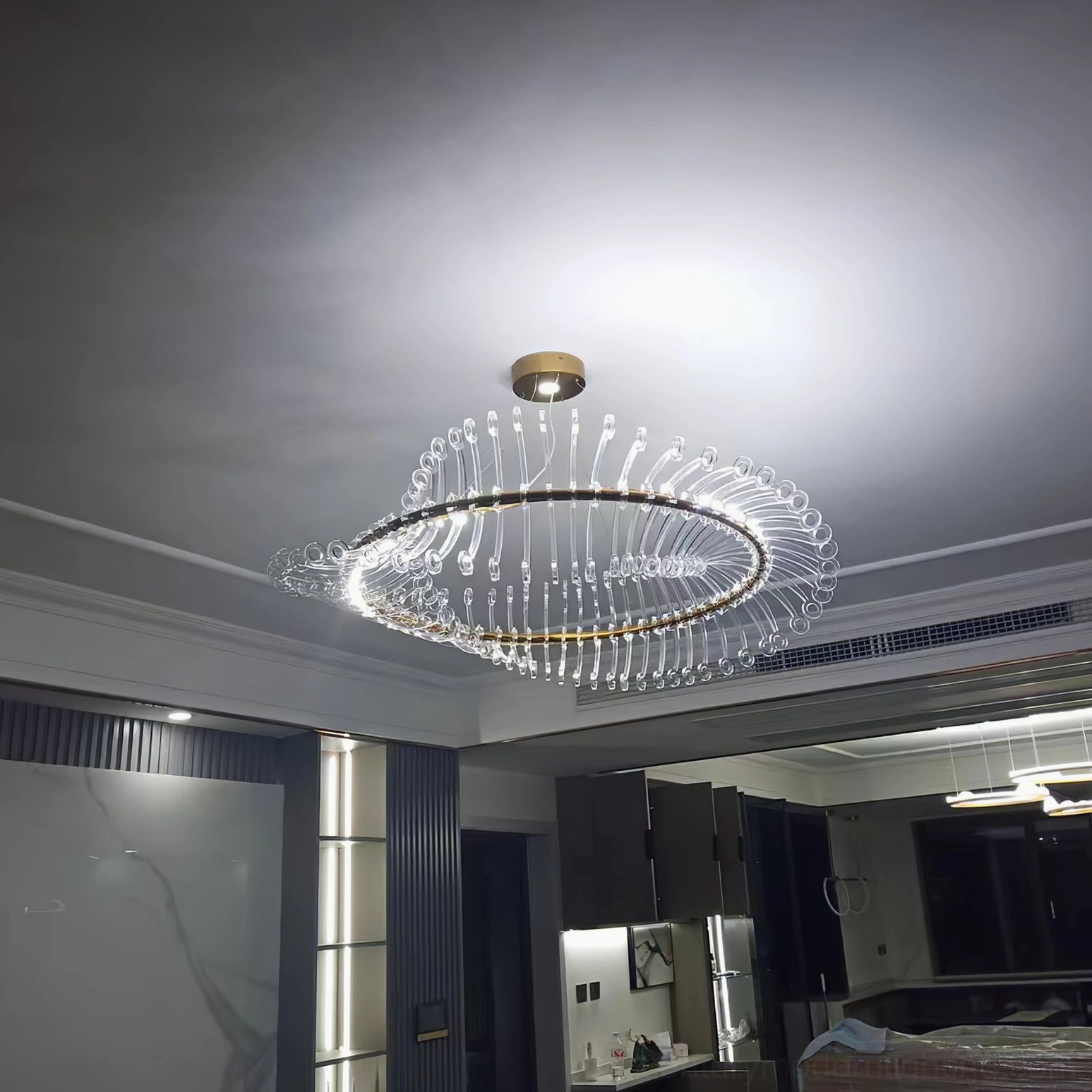 Contemporary gold Möbius strip chandelier bottom view illuminated with integrated LED warm light