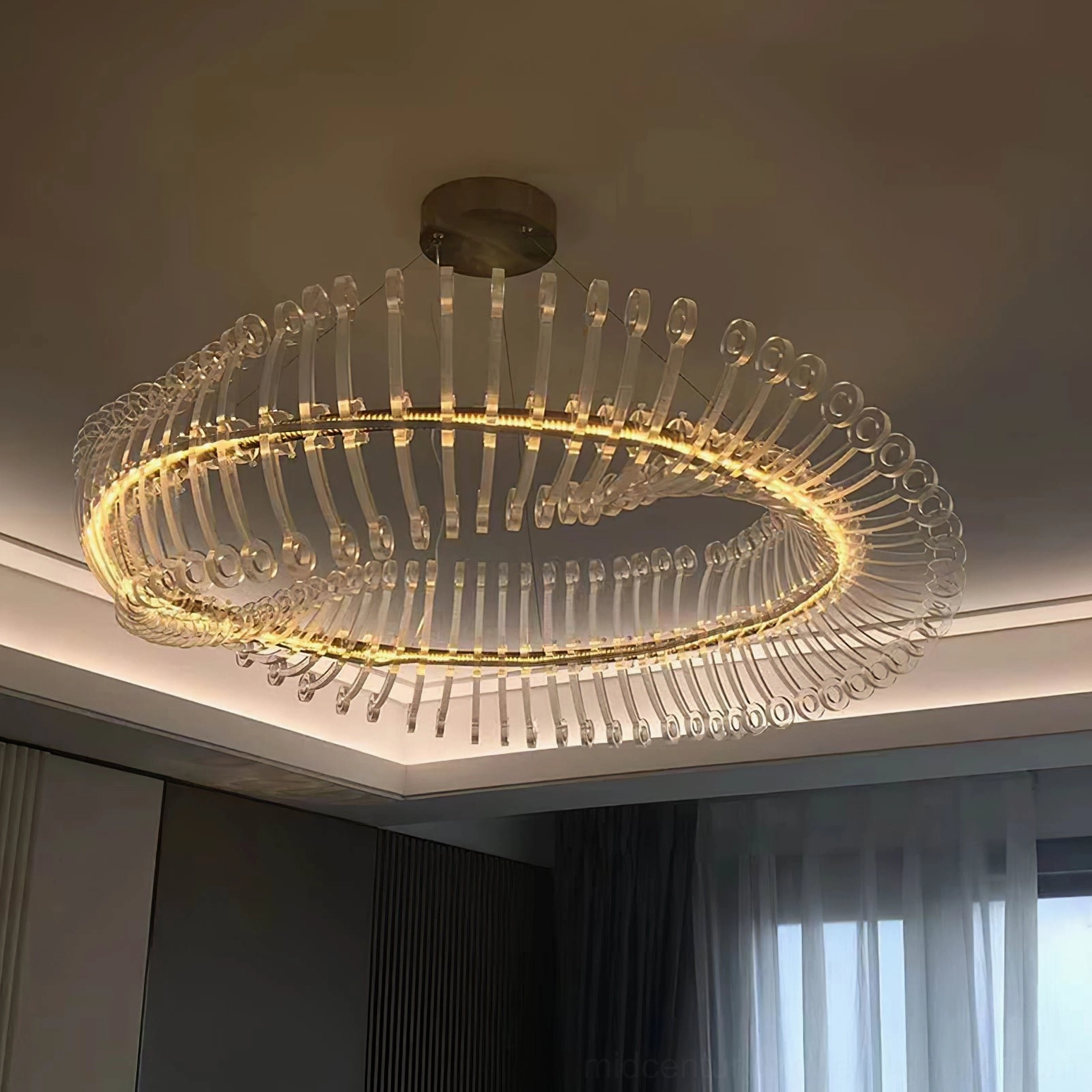 Modern gold Möbius strip chandelier with integrated LED showing warm and cool light temperature comparison