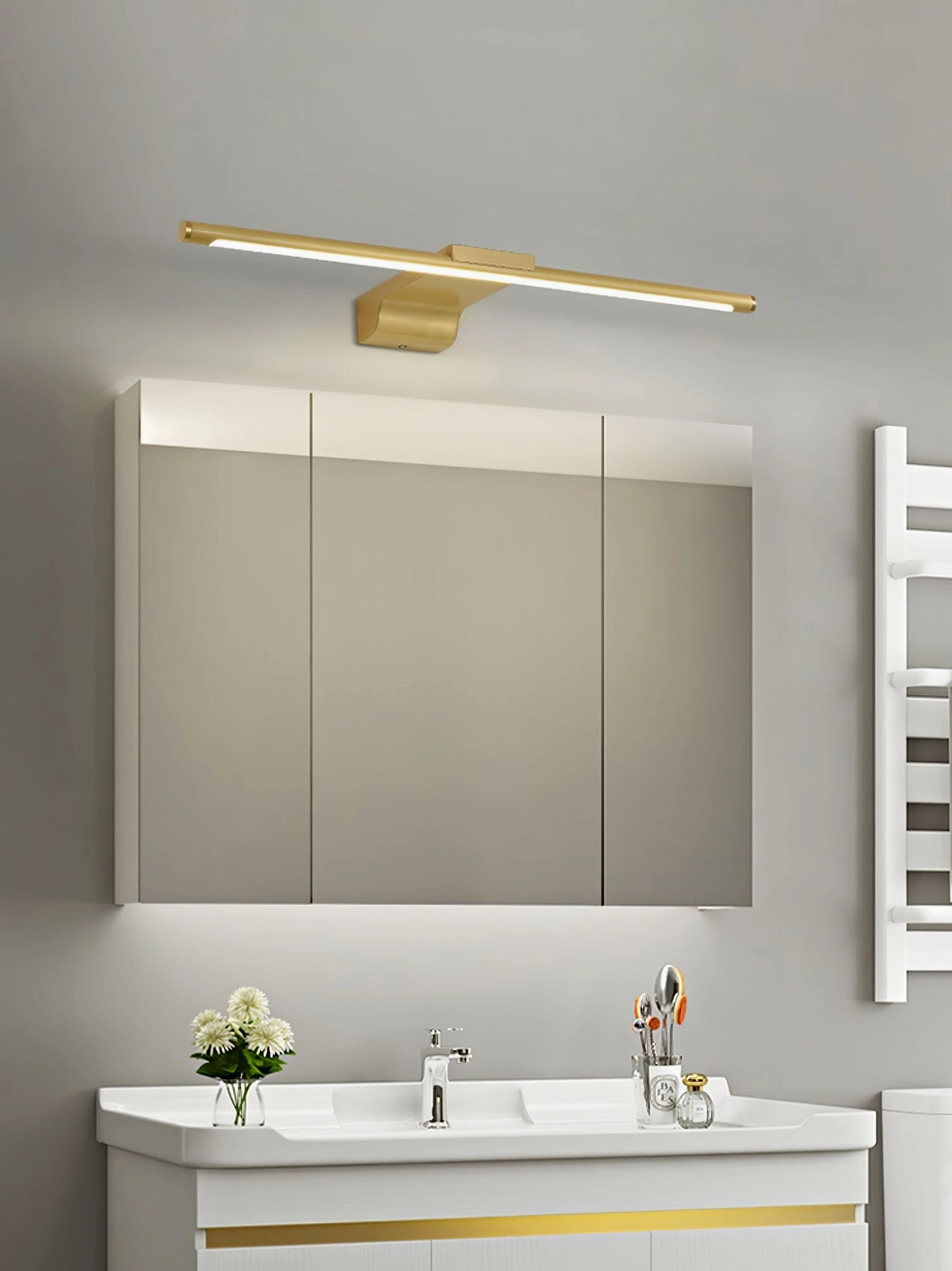 Modern bathroom lighting fixture with brass linear design and integrated LED