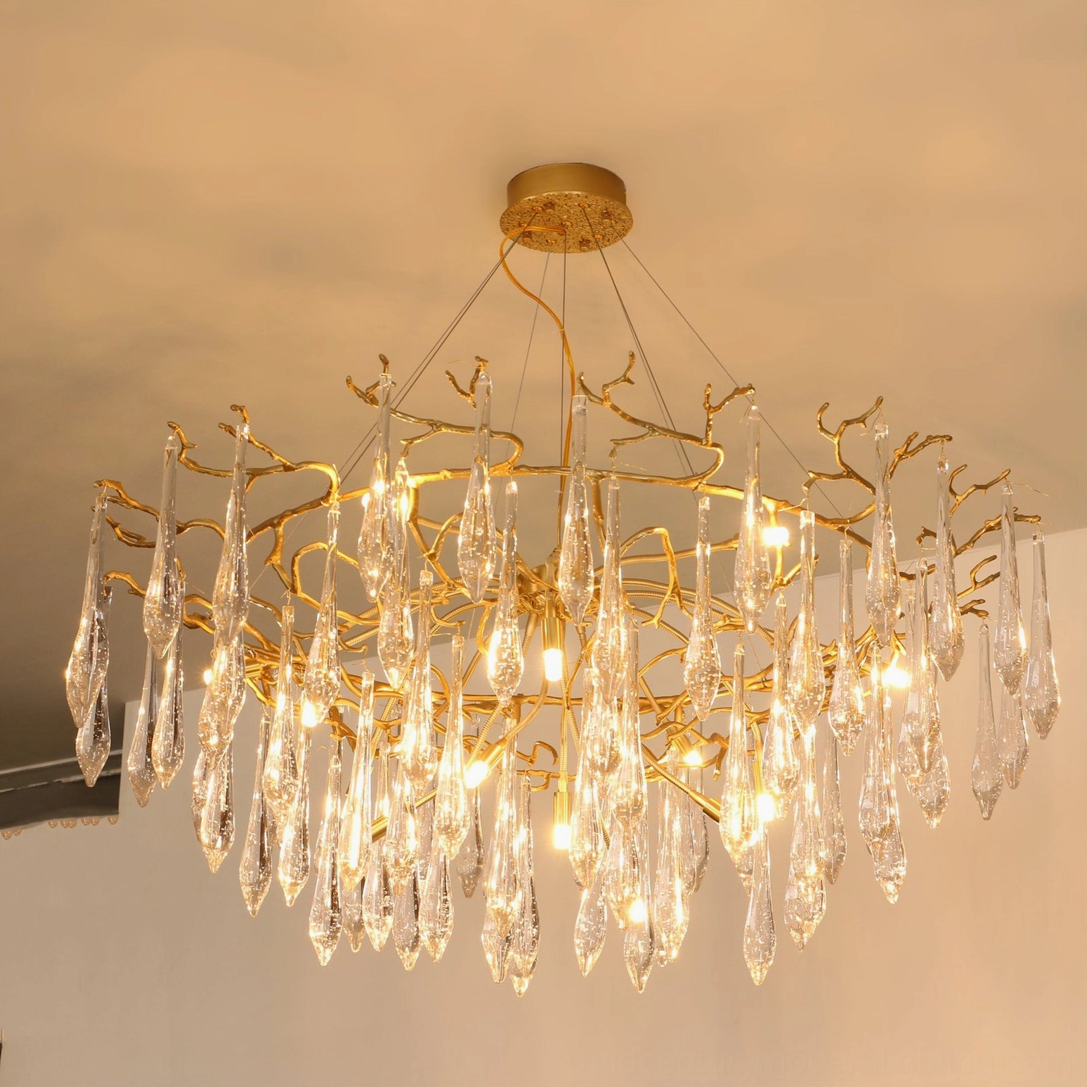 Modern brass chandelier showing warm tone finish and sculptural twig-inspired design