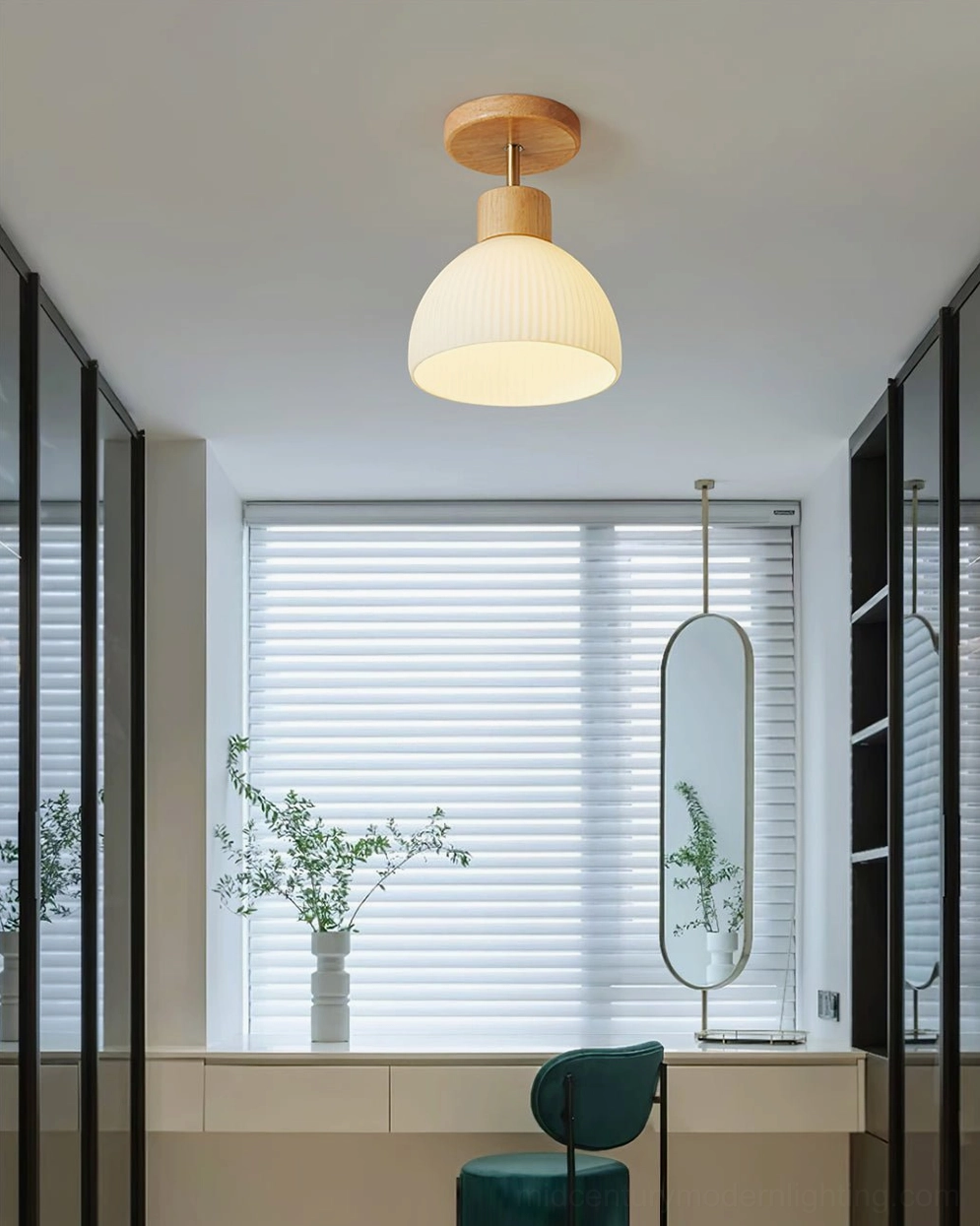 Semi-flush ceiling lamp mounted above vanity station with natural window light