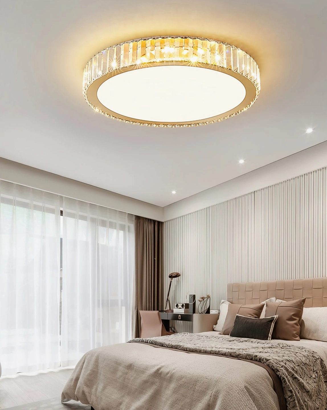 Ceiling-mounted crystal light fixture in bedroom with study desk and natural lighting