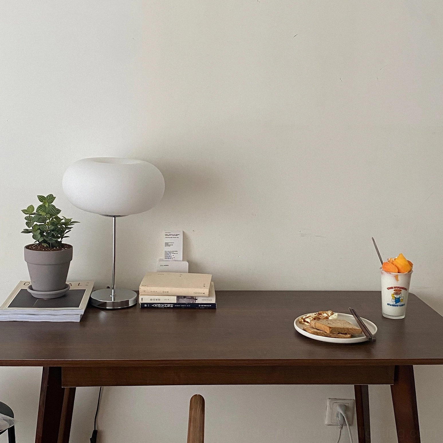 Modern frosted glass table lamp with chrome base, living room accent lighting design