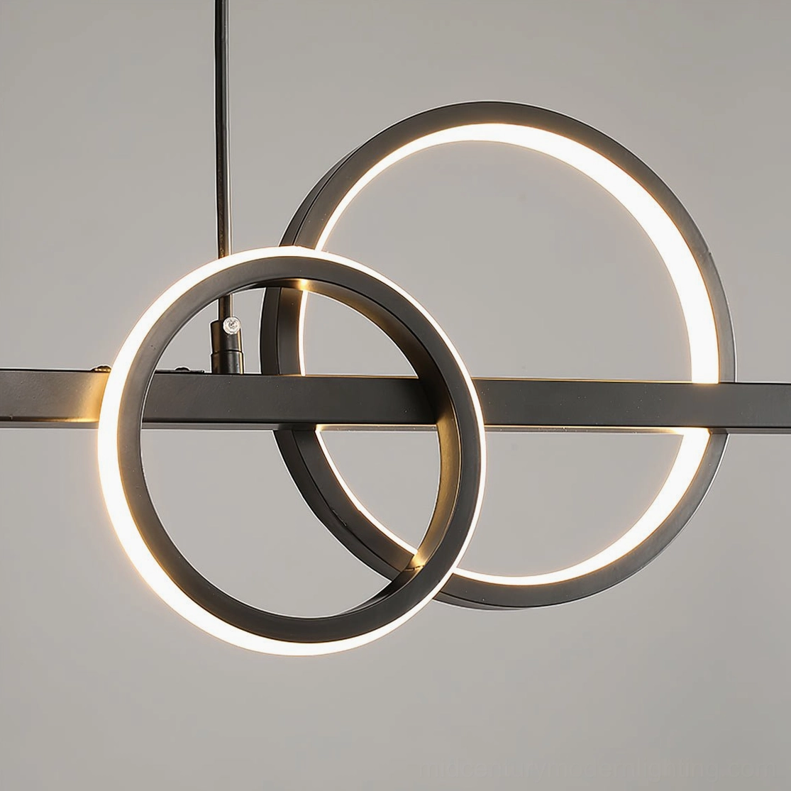 Modern glass bubble pendant light with black metal frame creating ambient illumination in sleek interior space