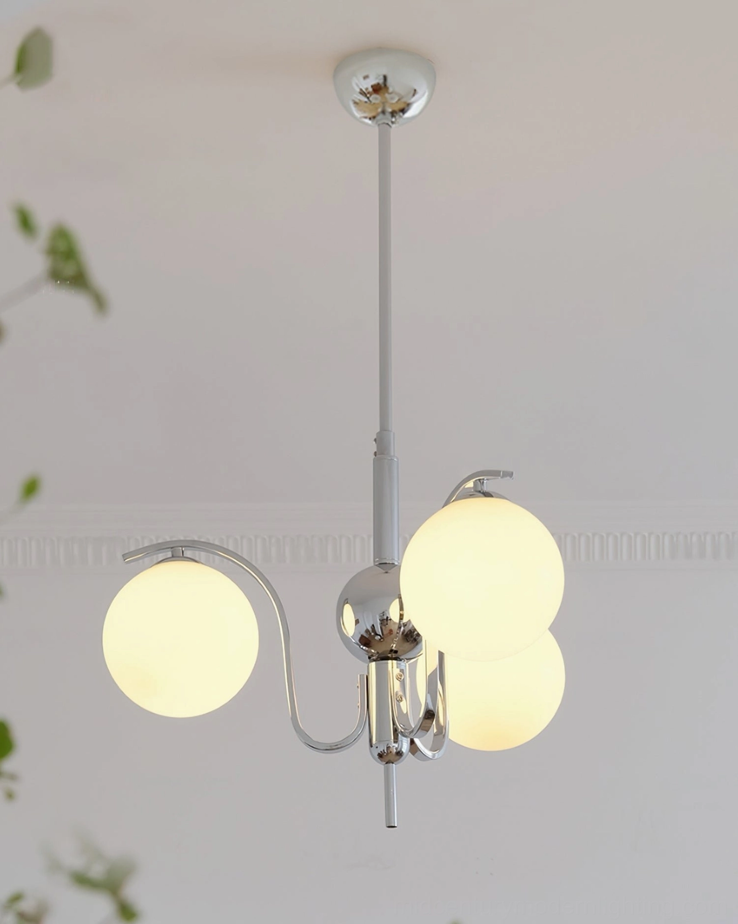 Modern glass sphere chandelier suspended from ceiling with balanced geometric arm structure