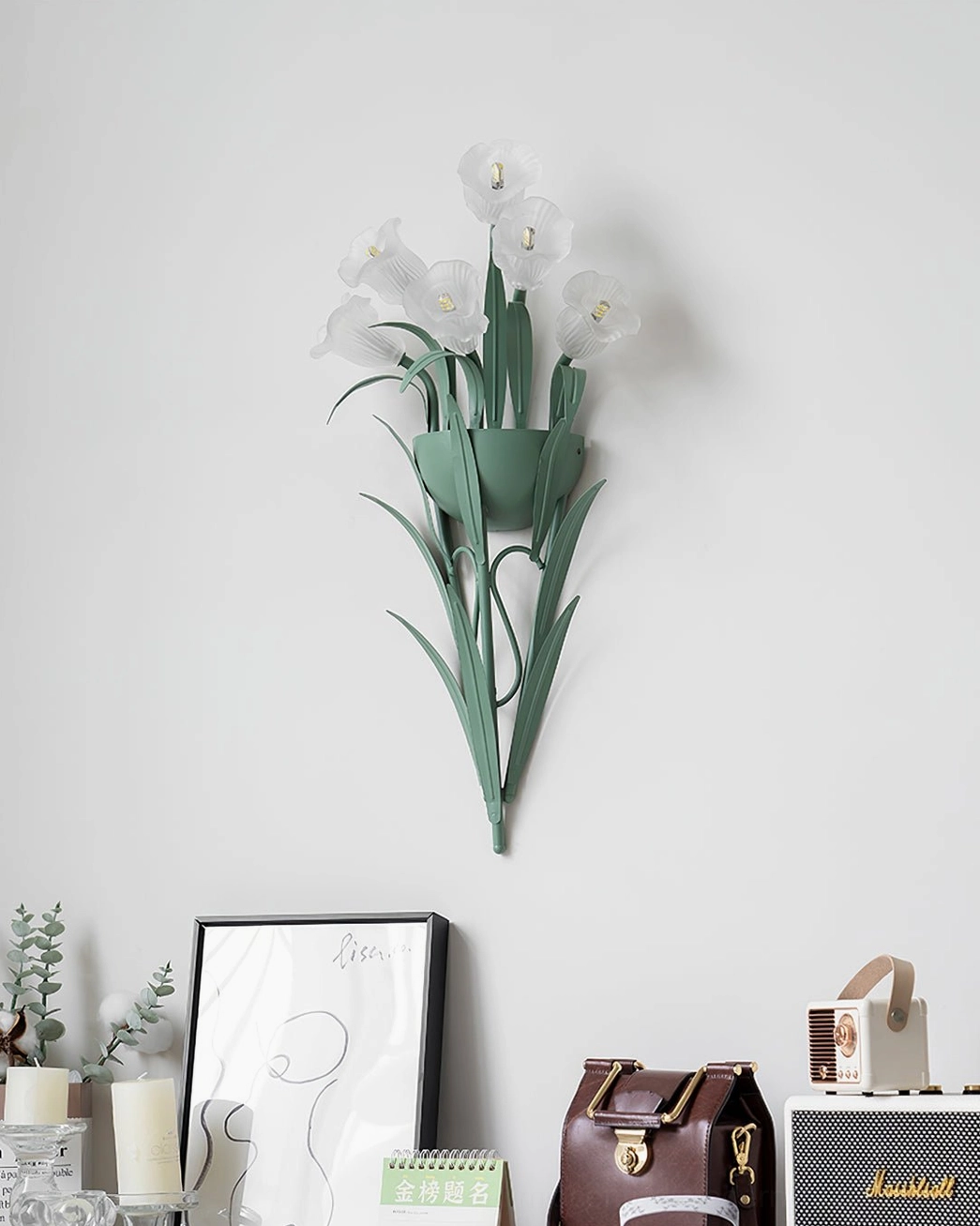 Calla lily wall sconce positioned in modern interior setting with botanical aesthetic