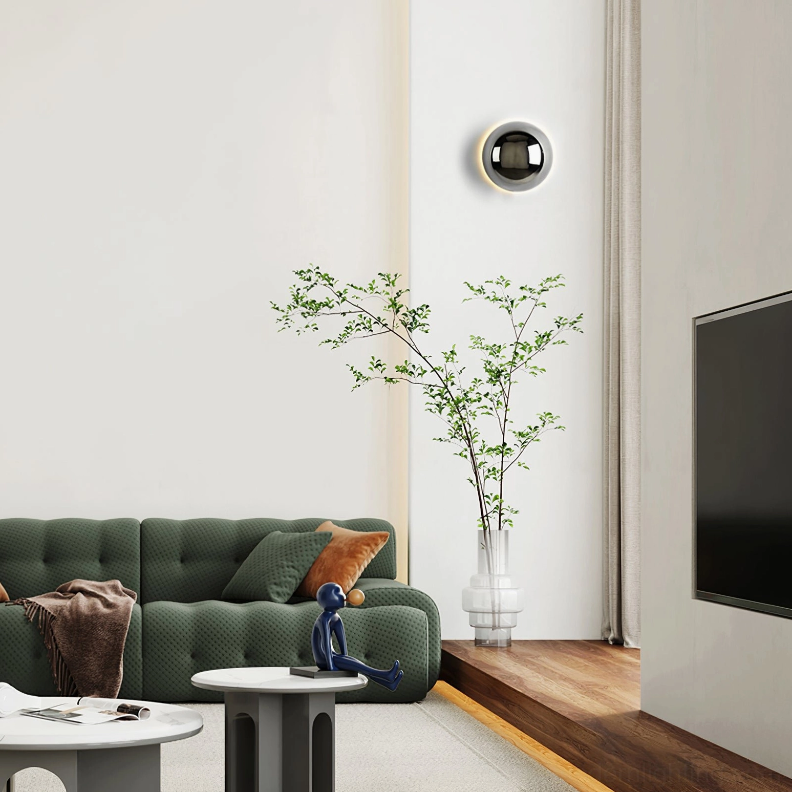 Minimalist chrome wall lamp installed in modern living room with green sofa interior design
