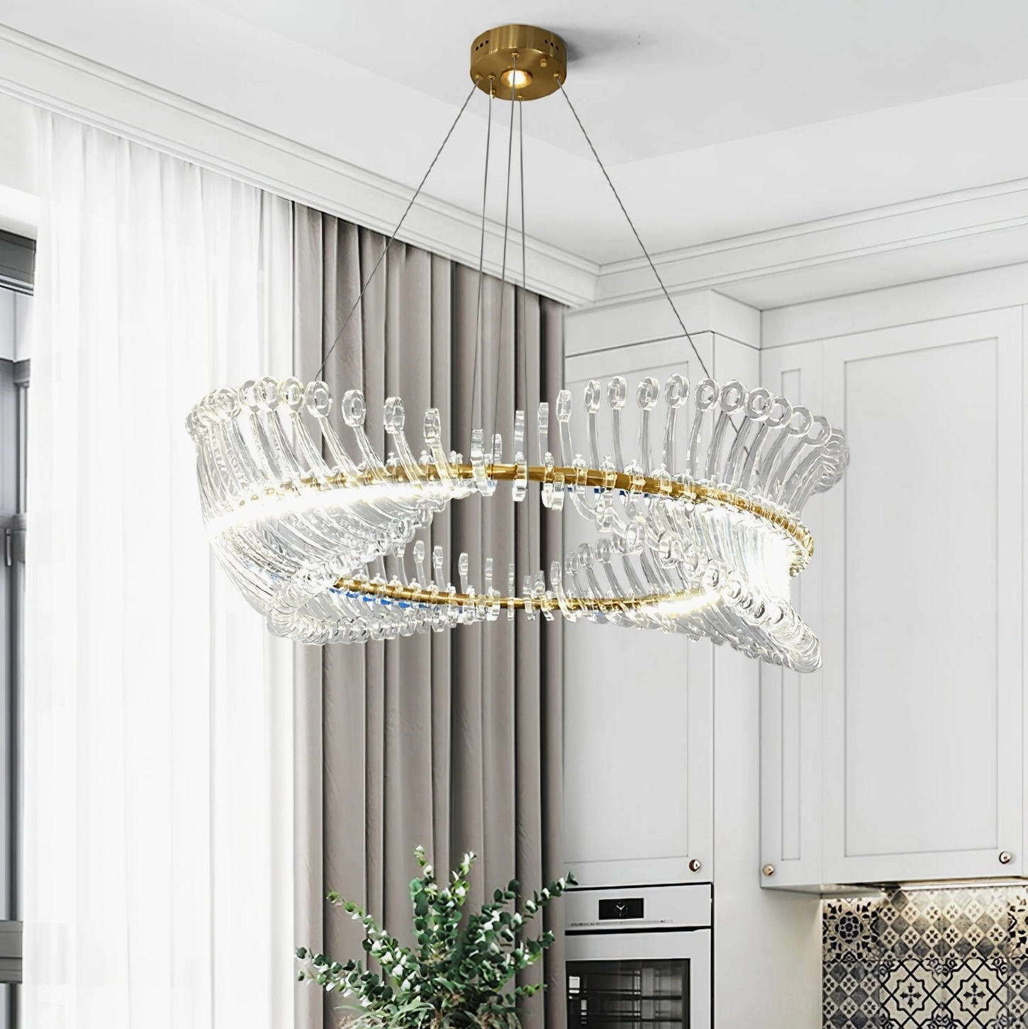 Contemporary gold Möbius crystal chandelier installed in luxury modern kitchen, warm LED illumination from below