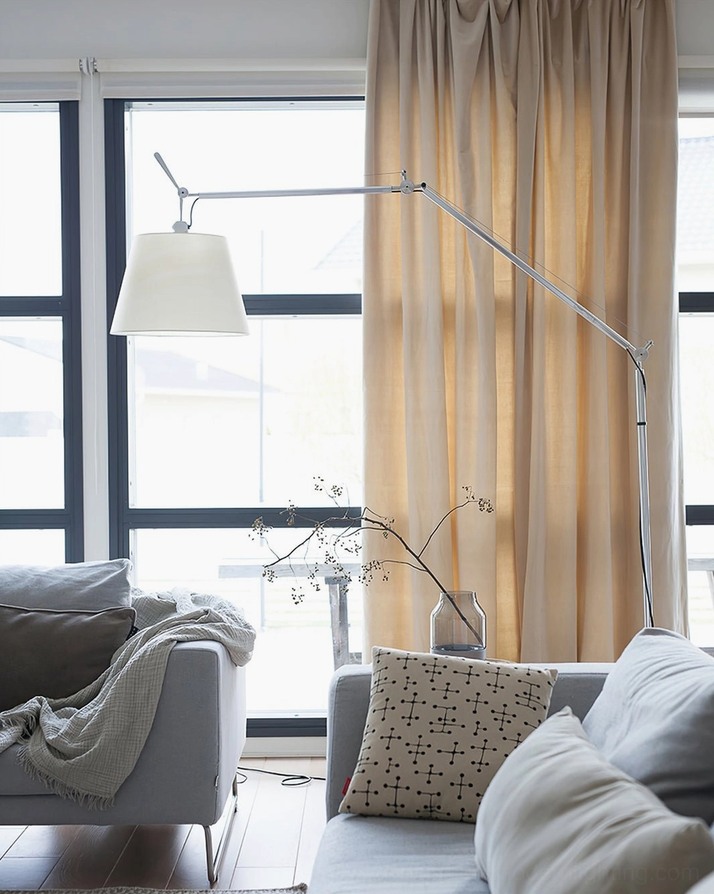Modern swing arm floor lamp detail, adjustable fabric shade and precision metal framework engineering