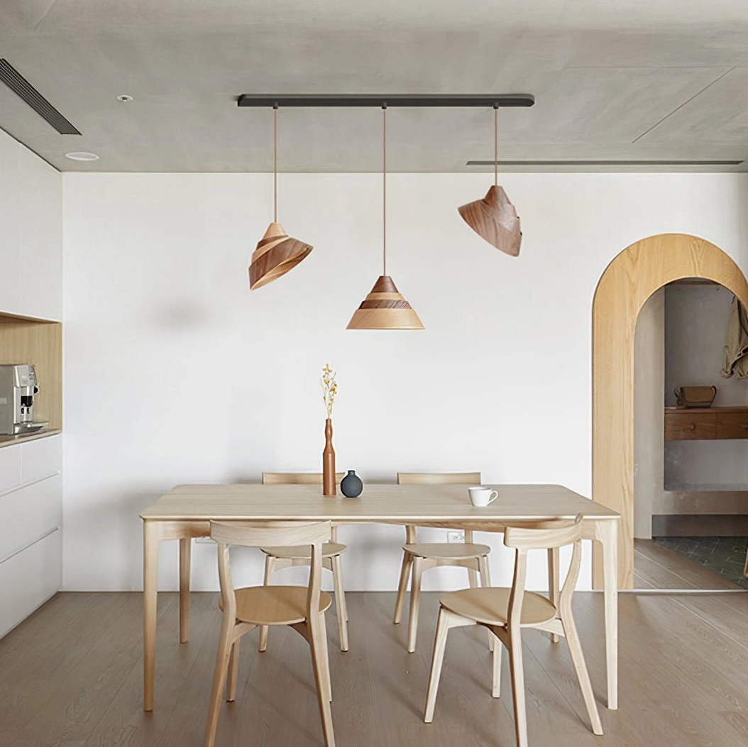 Multiple Moku pendant lights suspended in modern Nordic dining room, warm wood tones illuminated over dining table