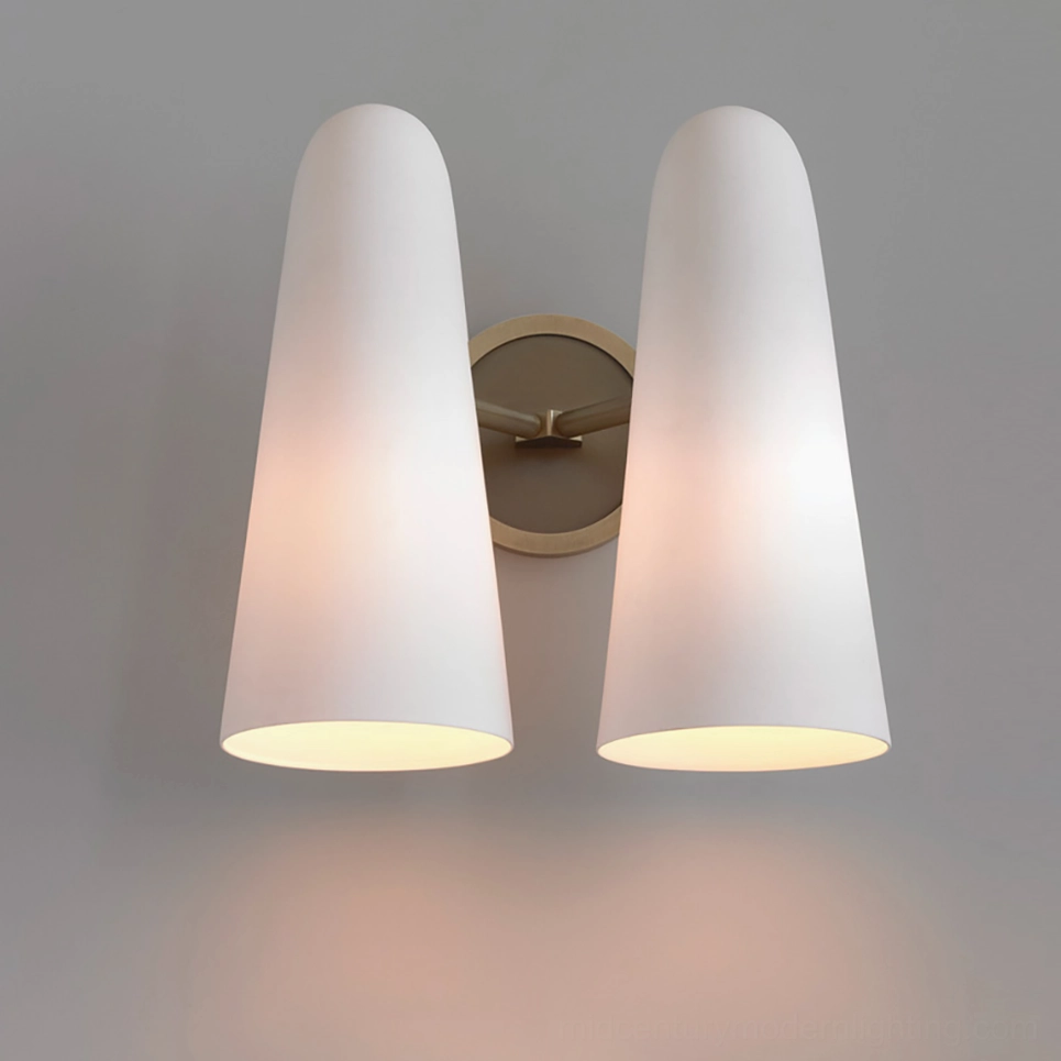 Two-head Montfaucon wall sconce studio product shot with round brass base and dual frosted white glass shades