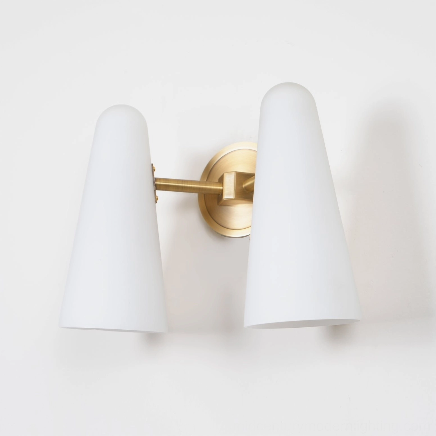 Montfaucon wall sconce angle view with brass bracket and translucent frosted glass shade