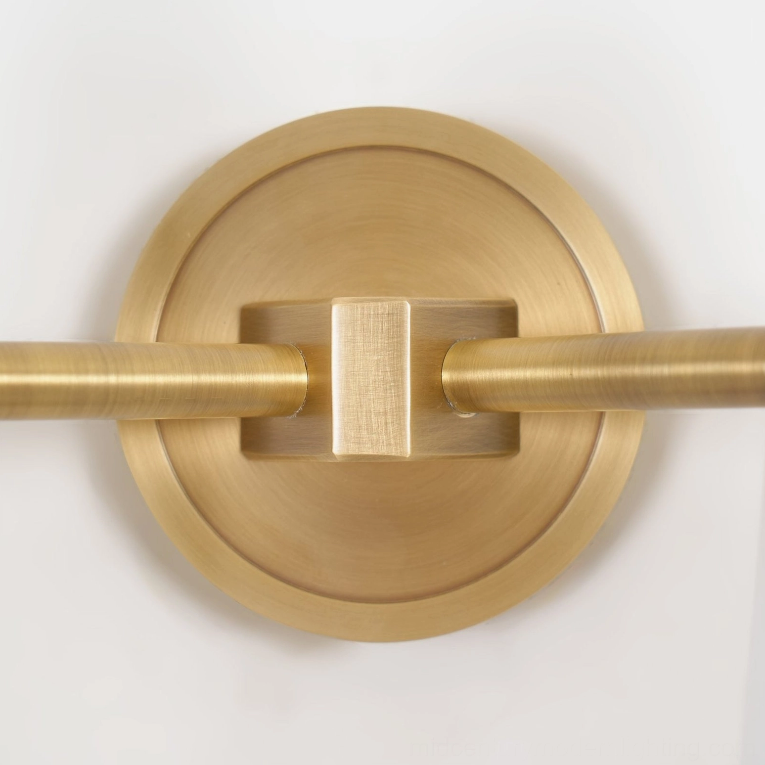 Montfaucon wall sconce front view displaying geometric cone form and warm brass finish