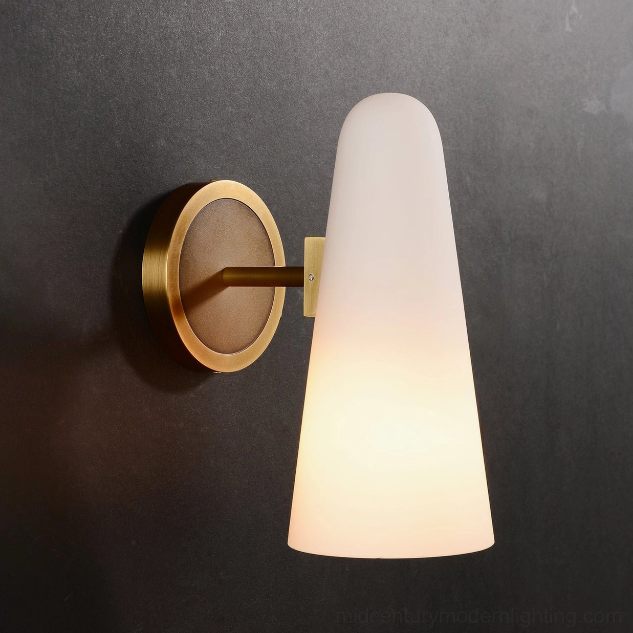 Single Montfaucon cone wall sconce with brass and wood base on dark charcoal wall background