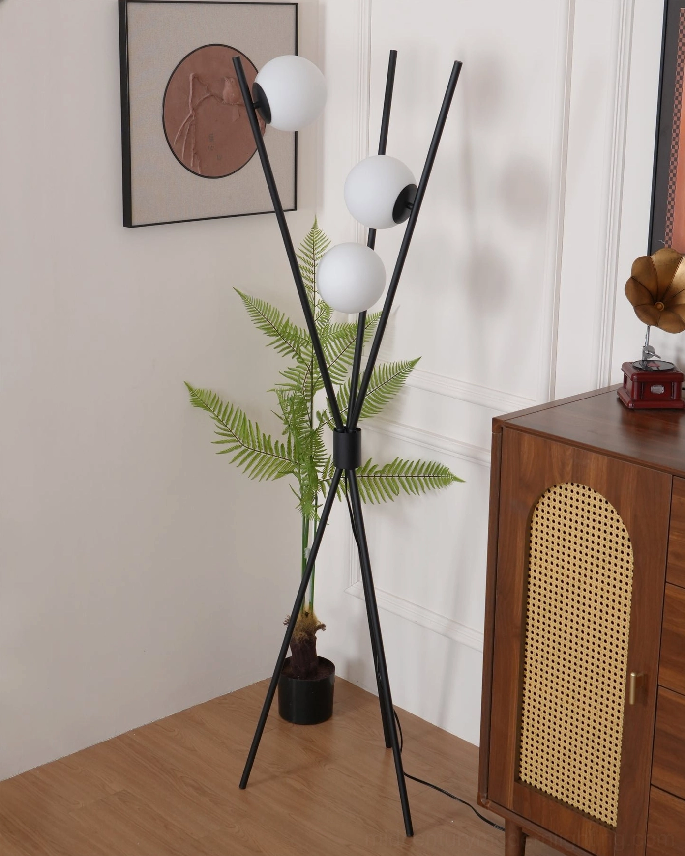 Moon Tripod Floor Lamp in botanical setting with tropical fern plant styling