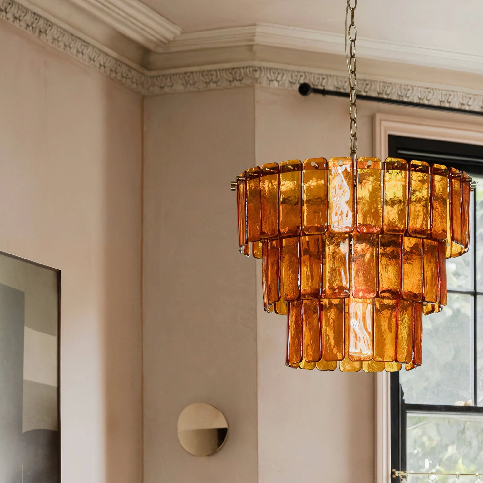 Moreland amber glass chandelier side view installed under crown molding ceiling