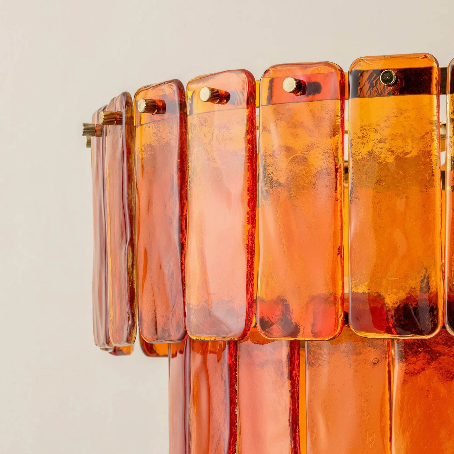 Moreland tiered glass chandelier full product view with warm orange amber finish