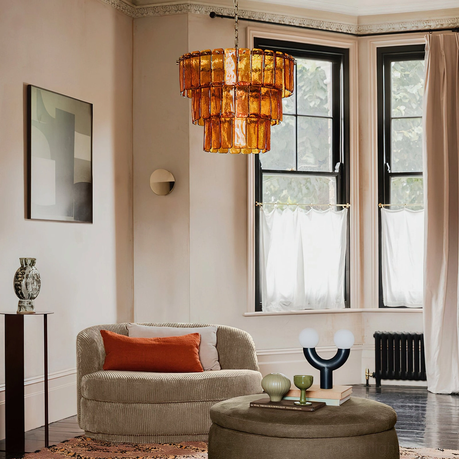 Moreland tiered glass chandelier installed in modern luxury living room with natural windows