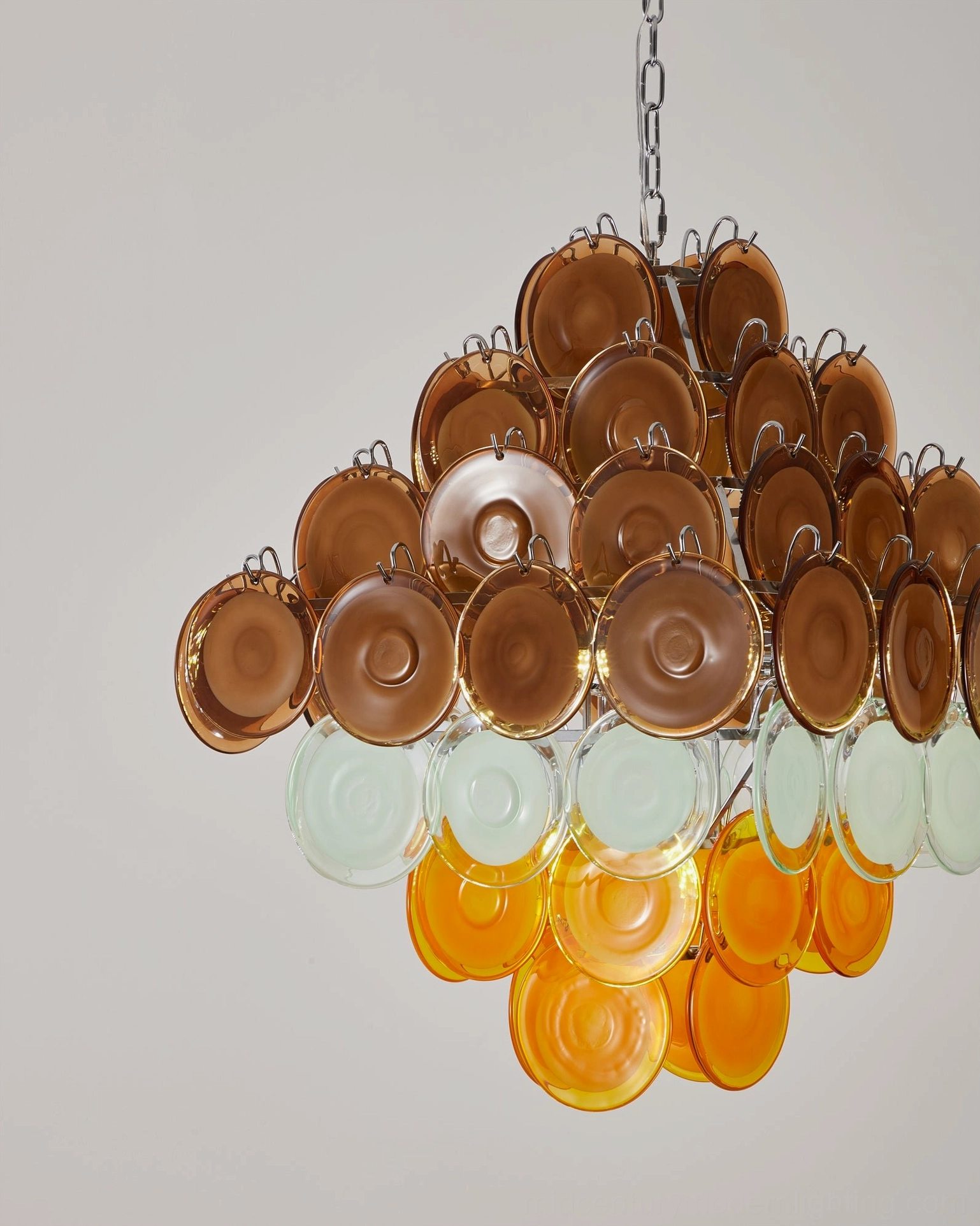 Mortimer glass chandelier three-quarter view showing reverse color gradient from brown to pale orange and white