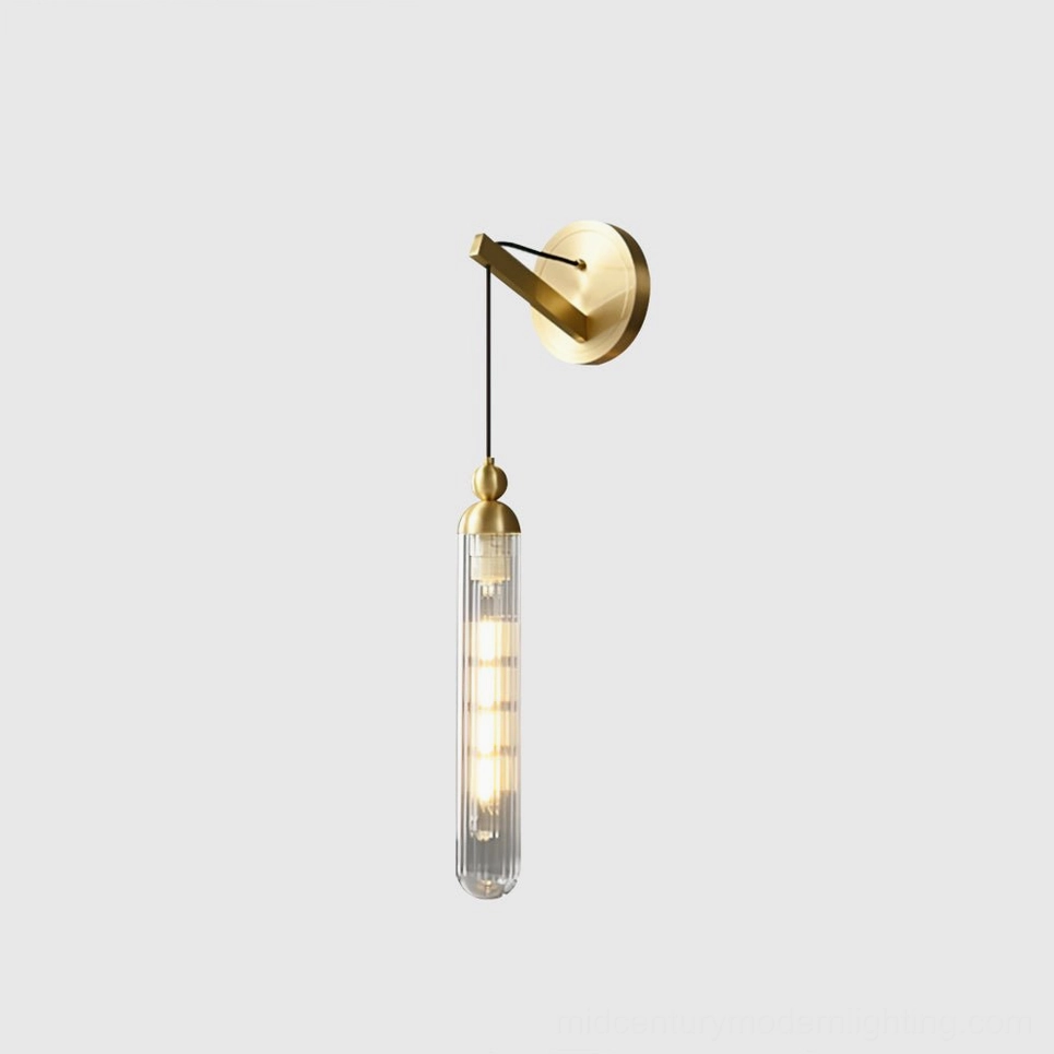 Brushed brass Mullan wall lamp with clear glass cylinder shade, side front studio view detail