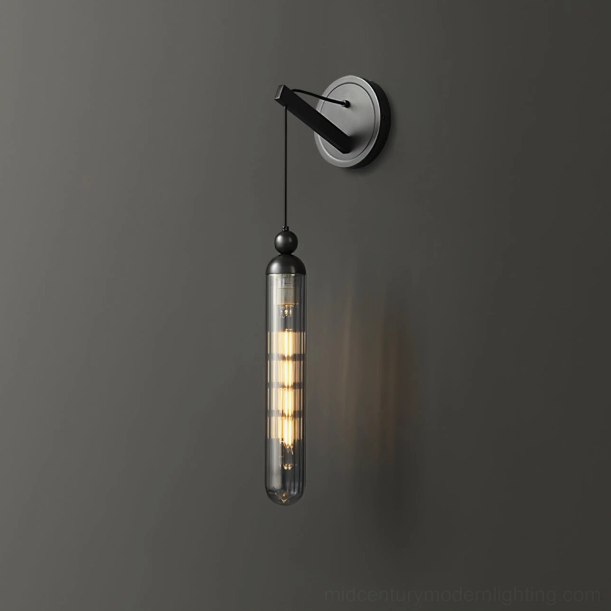 Mullan minimalist wall sconce installation detail showing mounting bracket and glass cylinder
