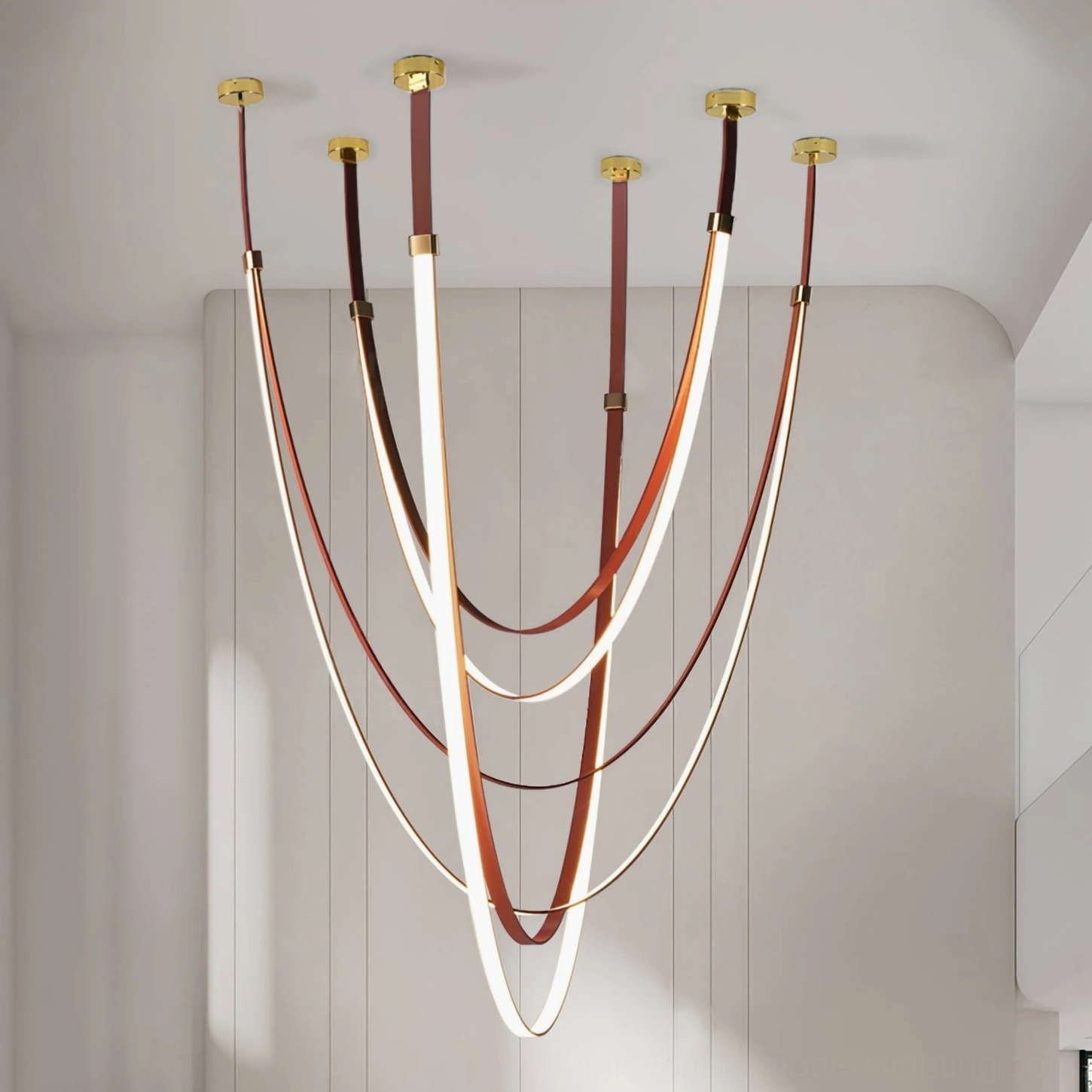 Multi-branch modern pendant chandelier with gold hardware, brown leather straps and layered glowing LED design in contemporary living room