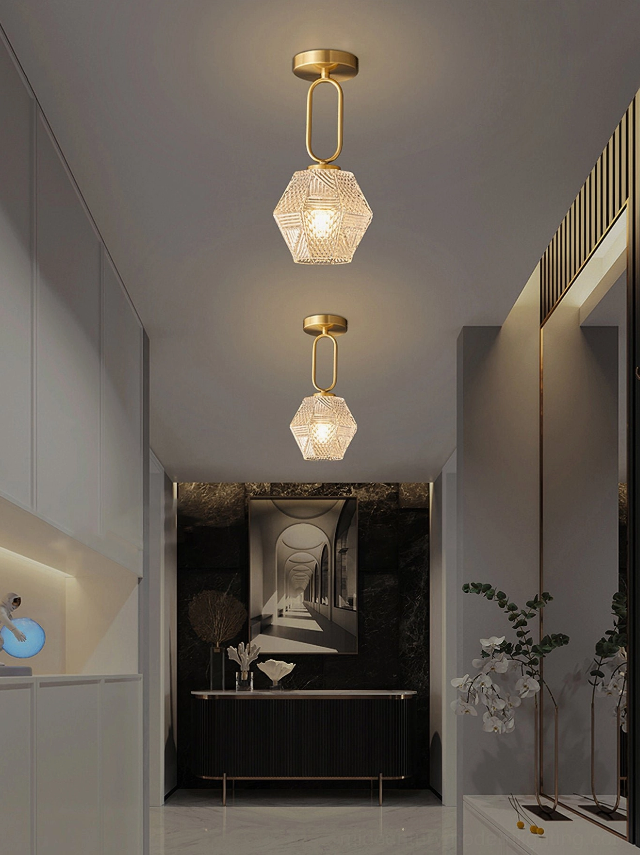 Row of two diamond cut ceiling fixtures with brass finish in long modern hallway