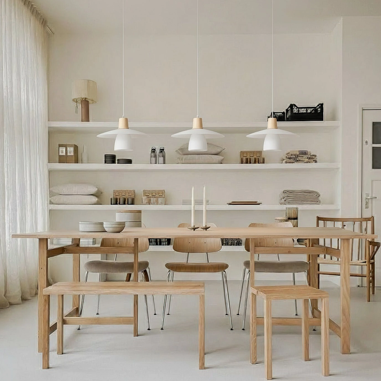 Set of pendant lights uniformly suspended above large open dining space in commercial scandi setting