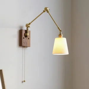Model A brass swing arm wall lamp with warm ambient light, illuminated pleated ceramic shade creating soft glow in modern interior