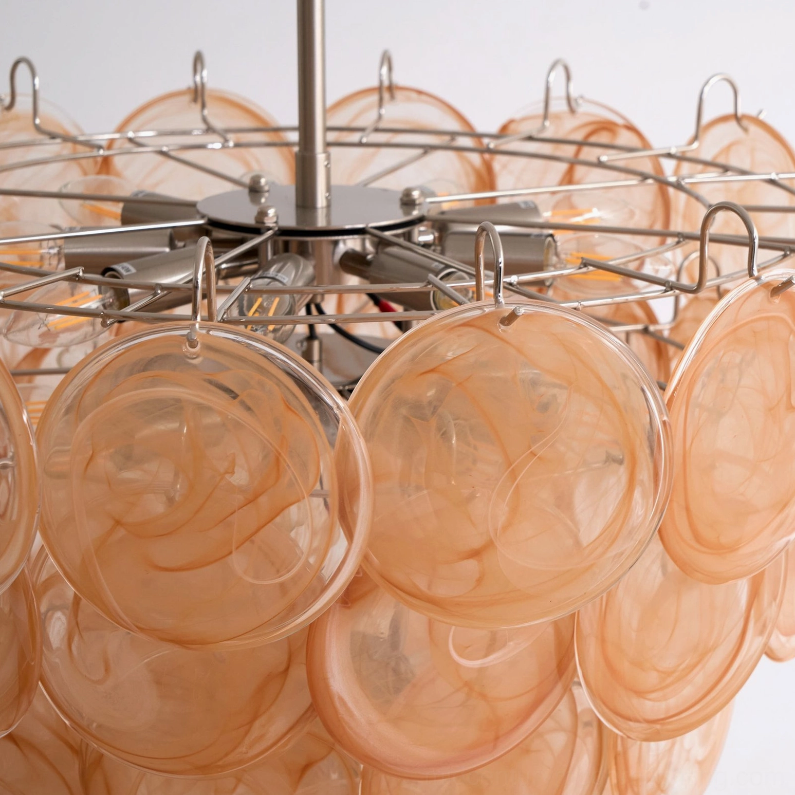 Murano caramel disc chandelier extreme close-up of metal hanging hooks and marbled caramel glass texture