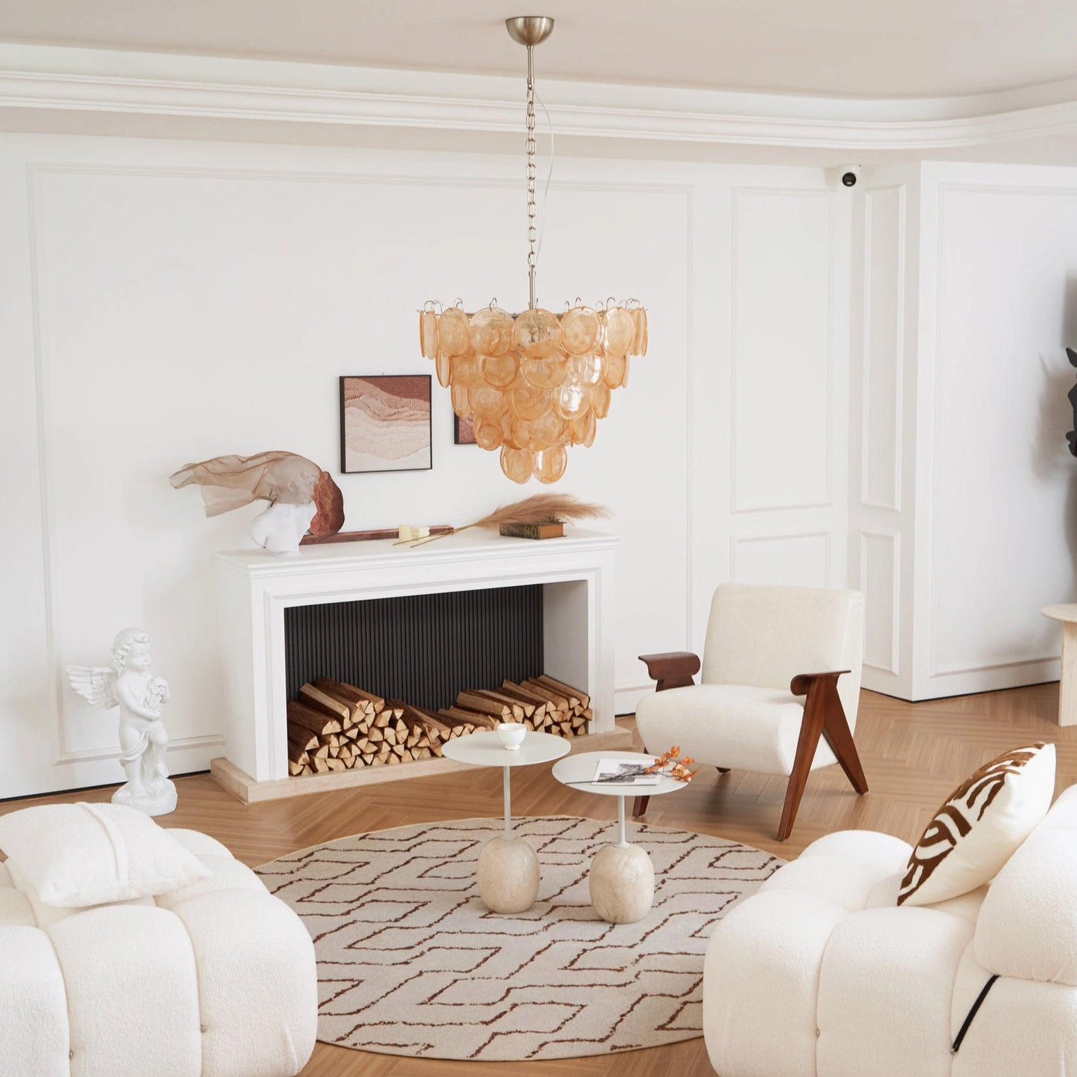 Murano caramel disc chandelier in cozy modern living room with geometric patterned area rug below