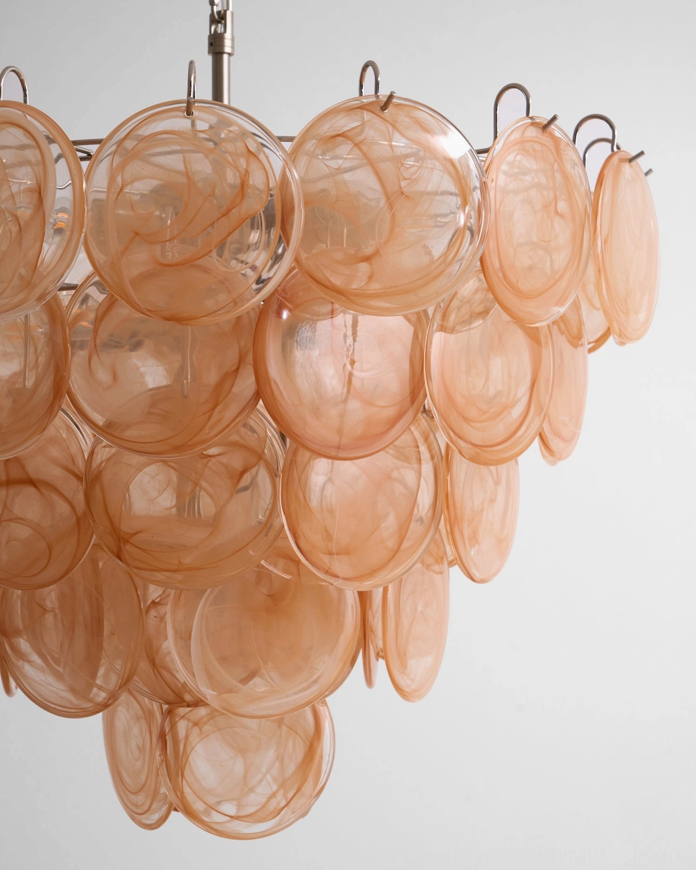 Murano caramel disc chandelier side angle showing warm translucent glass swirl pattern and depth